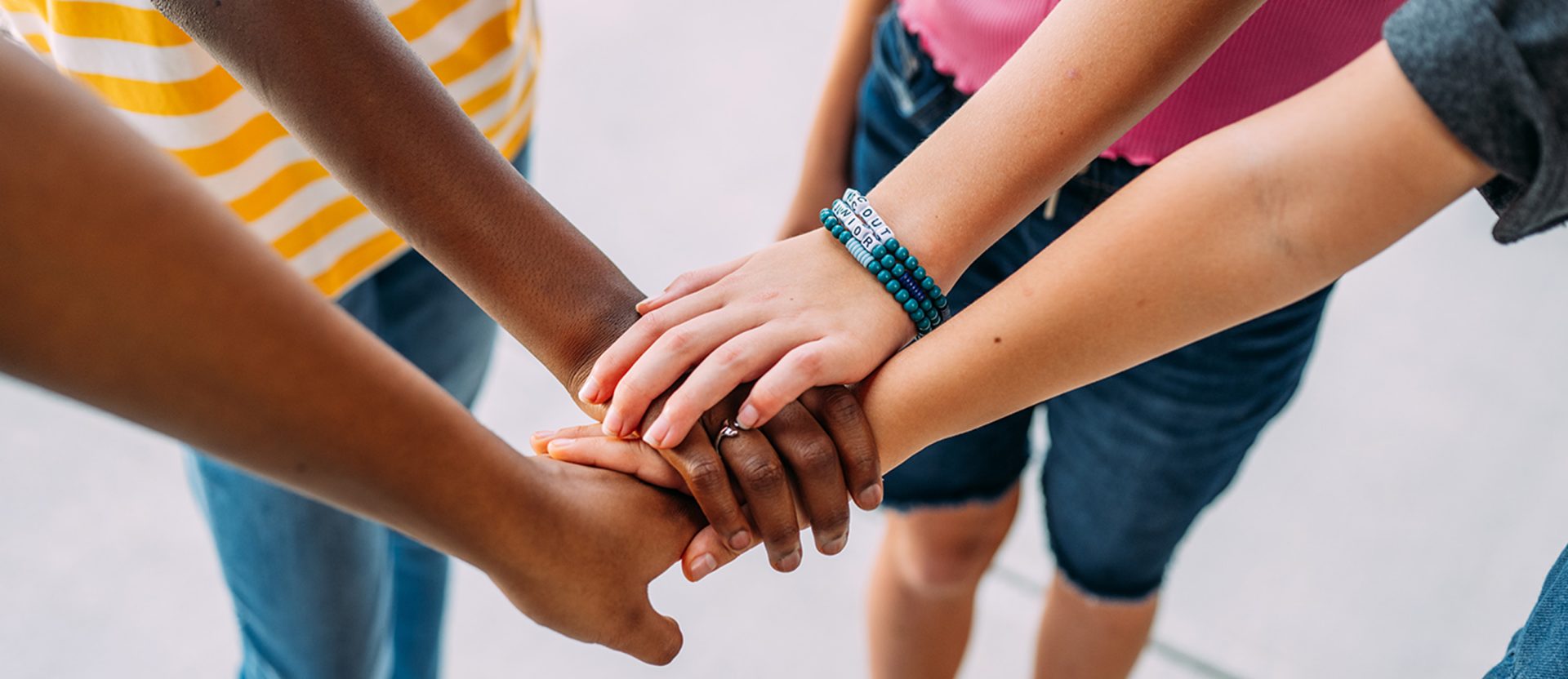 the stacked hands of a Girl Scout troop